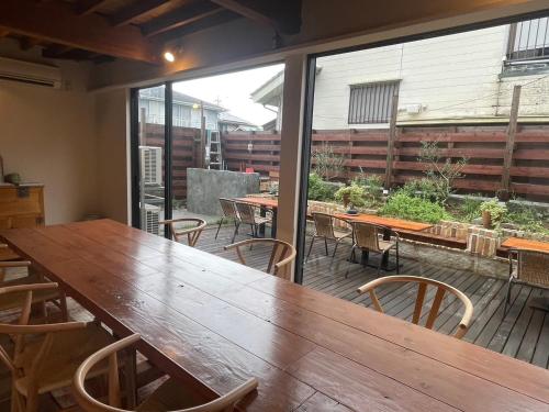 a large wooden table and chairs on a patio at AGASA residence in Fujieda