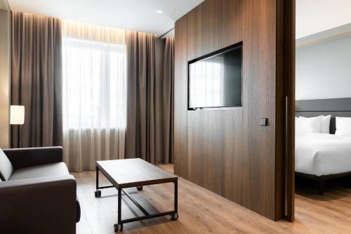 a hotel room with a bed and a television at AC Hotel by Marriott Riga in Rīga