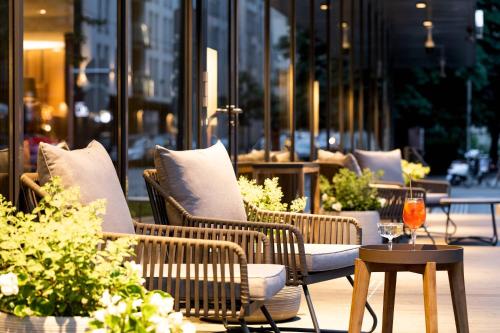 a group of chairs and a table on a patio at AC Hotel by Marriott Riga in Rīga