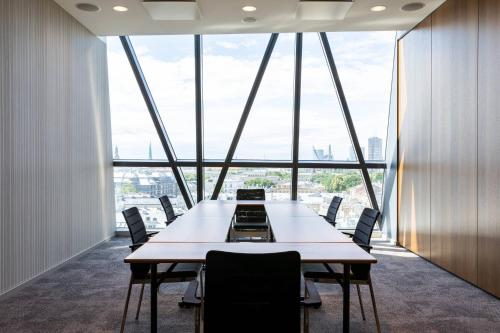 a conference room with a large table and chairs at AC Hotel by Marriott Riga in Rīga