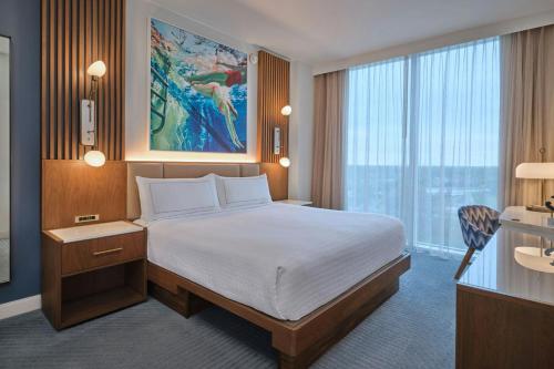 a hotel room with a bed and a large window at Walt Disney World Swan Reserve in Orlando