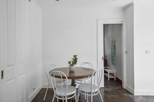 a dining room with a table and chairs at Charming House in Woolwich in Sydney