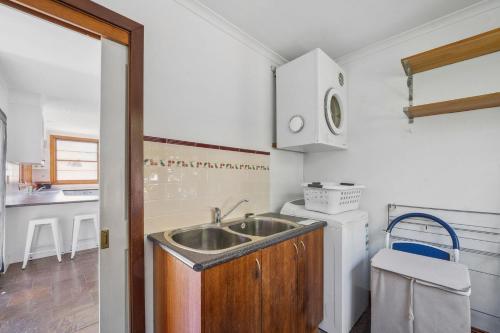 a kitchen with a sink and a counter at Charming House in Woolwich in Sydney