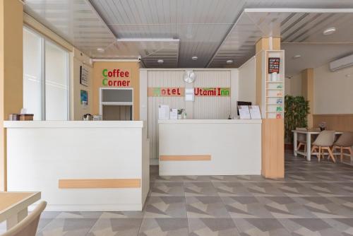 a lobby of a coffee center with tables and chairs at Urbanview Syariah Utami Inn Garut by RedDoorz in Garut