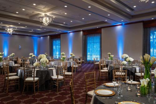 a ballroom filled with tables and chairs with flowers at Renaissance Dallas Richardson Hotel in Richardson