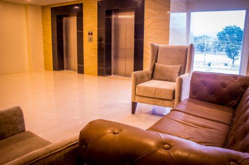 a living room with a couch and a chair at Royce Hotel & Casino in Clark