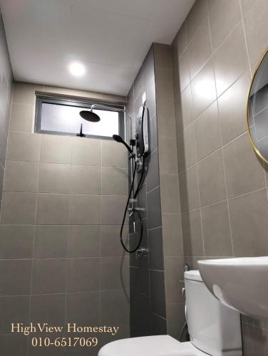 a bathroom with a shower and a toilet and a sink at HighView Homestay in Bandar Baru Bangi