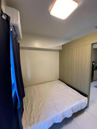 a small bed in a small room with a ceiling at Breeze Residences 26th floor in Manila