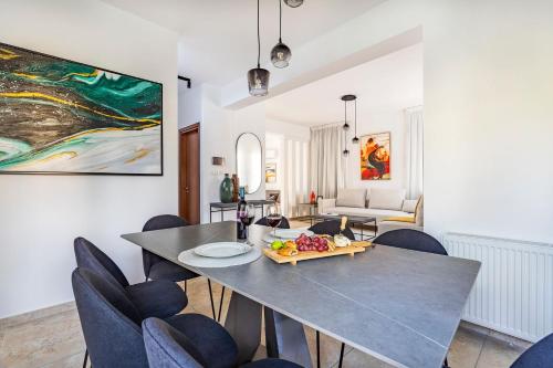 a dining room with a table and chairs at Agios Tychon Luxury Villa with Private Pool in Limassol