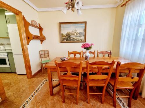 a dining room with a wooden table and chairs at Beachfront Bungalow In La Mata, Torrevieja in Torrevieja