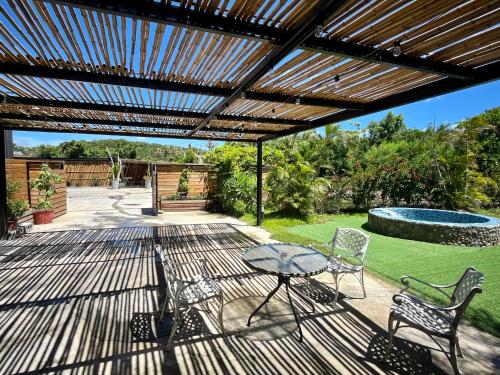 a patio with a table and chairs and a pool at 夏日禾風庭園包棟 in Checheng