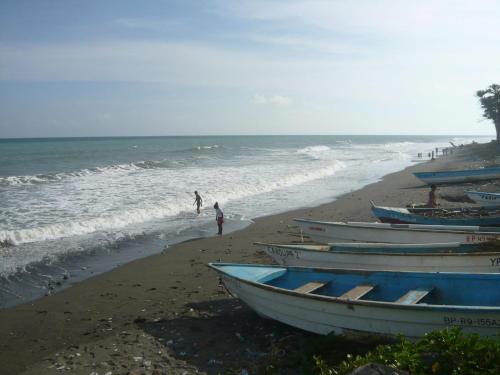 a group of boats sitting on the beach at Villa Los Almendros - 2 private pools tennis pickle ball in Baní