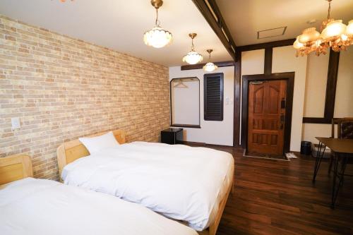 Ένα ή περισσότερα κρεβάτια σε δωμάτιο στο GOOD OLD HOTEL hirosaki