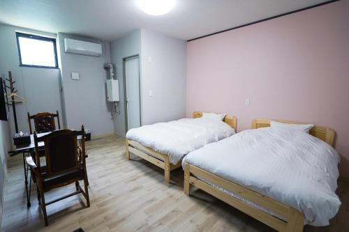 Ένα ή περισσότερα κρεβάτια σε δωμάτιο στο GOOD OLD HOTEL hirosaki