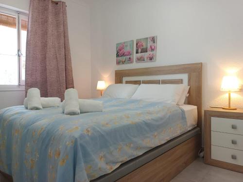 a bedroom with a bed with a blue comforter at Charming Bungalow in Torrevieja Near La Mata Natural Park in La Mata