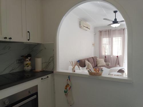an archway in a kitchen with a living room at Charming Bungalow in Torrevieja Near La Mata Natural Park in La Mata