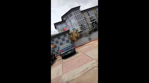 a car parked in front of a building at All Seasons Hotel - Executive in Owerri