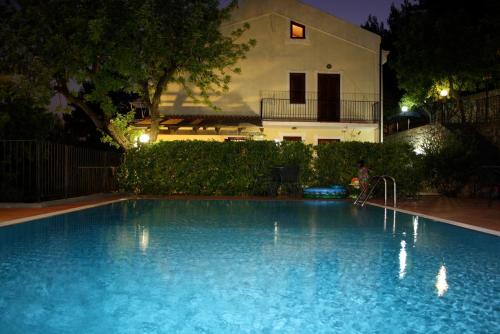 a swimming pool in front of a house at night at Il Casalino in Maratea