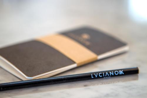 a close up of a pen and a book on a table at Hotel Luciano K in Santiago