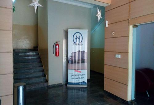 a staircase with a fire hydrant and a sign in a building at Wetland Hotels, Ibadan in Ibadan