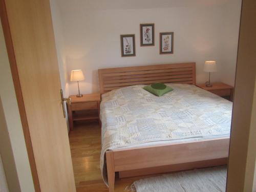 a bedroom with a bed and two lamps on tables at Ferienwohnungen Margreiter in Mitterbach