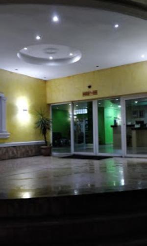 an empty lobby of a building with green lights at Habitat Hotel and Suites -Standard in Port Harcourt