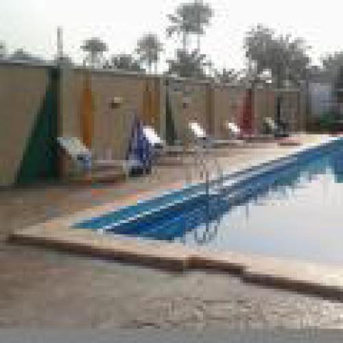 a swimming pool with blue lanes in a building at Habitat Hotel and Suites -Standard in Port Harcourt