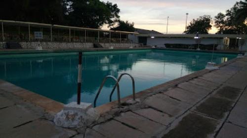 a swimming pool with blue water in a building at Premier Hotel-ibadan in Ibadan