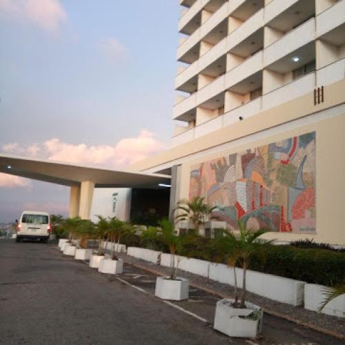 a car parked in front of a building with a mural at Premier Hotel-ibadan in Ibadan