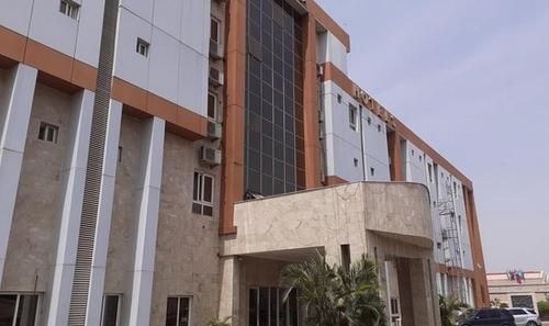 a building with a parking lot in front of it at Grand Cubana Hotels-alcove Room in Jabi
