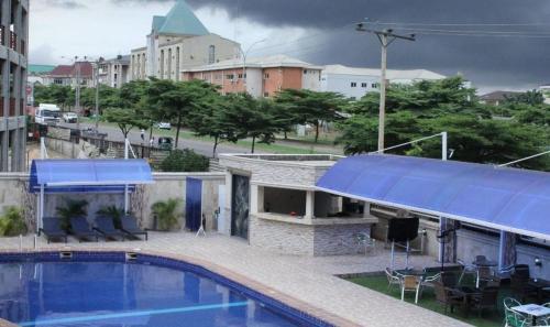 a swimming pool on the roof of a building at Grand Cubana Hotels-alcove Room in Jabi