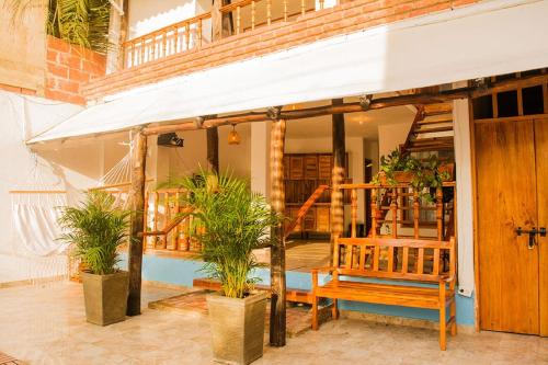 a house with a porch with a bench and plants at Hb3 Double Room with private bathroom facing the sea in Cartagena de Indias