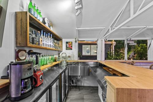 a kitchen with a bar with a counter top at Aspendale Beach House in Aspendale