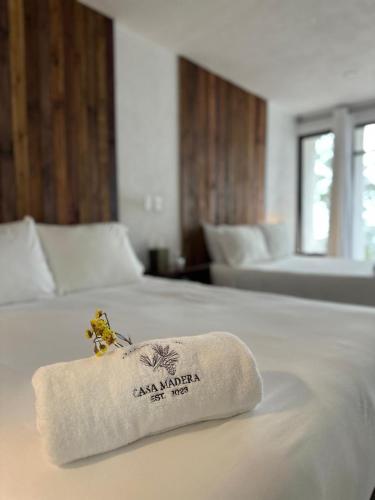 a hotel room with a towel on a bed at Casa Madera 2B in Zacatlán