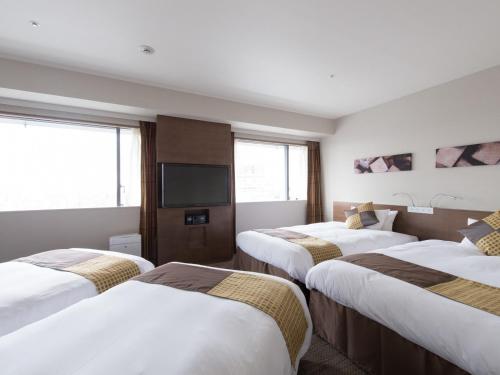 Postel nebo postele na pokoji v ubytování Hotel Keihan Kyobashi Grande