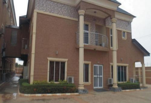 a large brick building with a balcony at Sheriffyt Royale Hotel - Business Suite in Ikorodu
