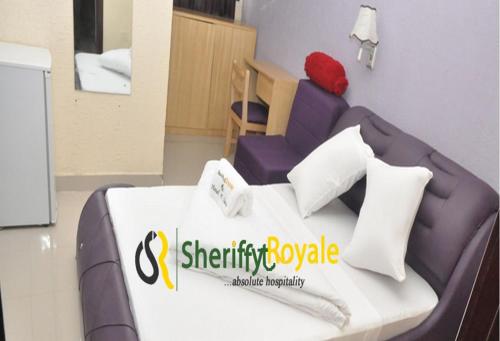a living room with a bed and a couch at Sheriffyt Royale Hotel - Business Suite in Ikorodu
