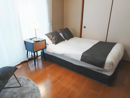 Ένα ή περισσότερα κρεβάτια σε δωμάτιο στο OUCHI HOTEL Kawaramachi