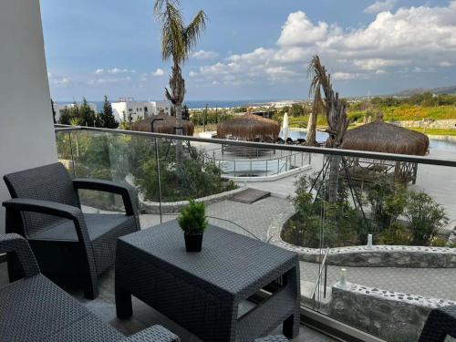 a balcony with a table and a view of the ocean at Modern and comfortable studio apartment in Ayios Nikolaos
