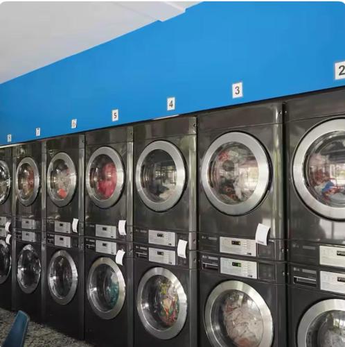 a row of washing machines in a laundrette at Natos Residences - St Francis in Bacolod
