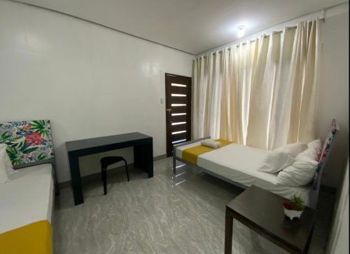 a small room with a bed and a fireplace at Natos Residences - St Francis in Bacolod