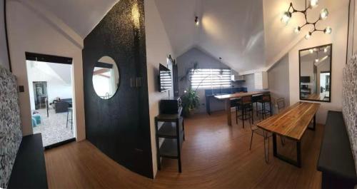 a living room with a table and a dining room at Natos Residences - St Francis in Bacolod