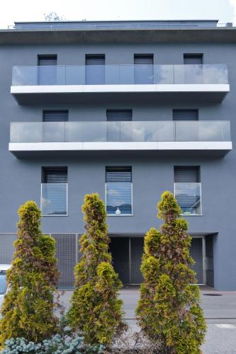 an apartment building with trees in front of it at Lake View Suite Melide in Melide