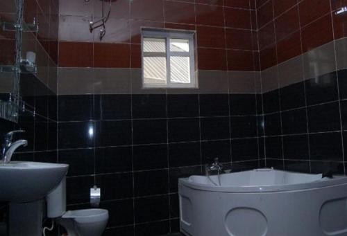 a bathroom with a toilet and a sink at Royal Park Hotel Suite - Standard in Asaba