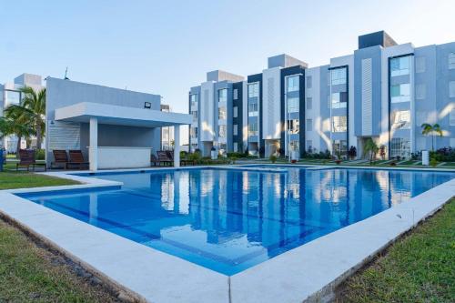 a swimming pool in front of a building at 2 Bedrooms and Pool Acapulco Penthouse in Gallinero