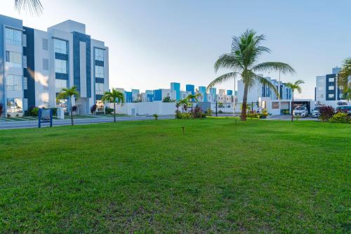 a park with palm trees in front of a city at 2 Bedrooms and Pool Acapulco Penthouse in Gallinero