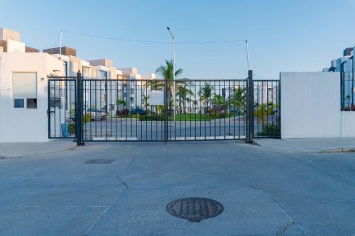 a metal gate with a manhole in front of a street at 2 Bedrooms and Pool Acapulco Penthouse in Gallinero