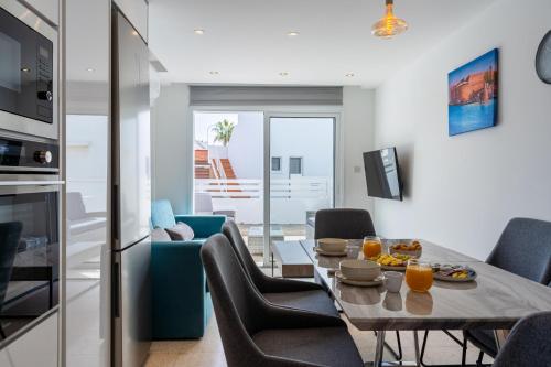 a kitchen and living room with a table and chairs at Pervolia Seaview Escape in Pervolia