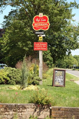 a sign for a fast food restaurant on a street at The Red Lion in Revesby