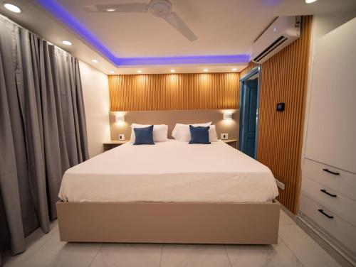 a bedroom with a large bed with blue lighting at Garden Condos 39, Luxury Apartment In Sosua Town in Sosúa